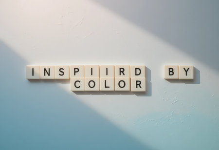 A creative composition featuring letters spelling "Inspired by Color" against a soft background, beautifully highlighted by light and shadow. Ideal for art and design themes.の素材