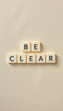 This image features an inspiring message that reads "BE CLEAR," arranged neatly with letter tiles on a soft background. Perfect for communication themes.の素材
