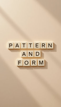 A visually striking image of letter blocks displaying the words "Pattern and Form," set against a minimalist beige background, creating a compelling aesthetic.の素材