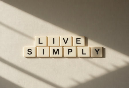 A visually appealing flat lay image featuring the words "Live Simply" arranged thoughtfully with natural light creating striking shadows, perfect for inspiring a minimalist lifestyle.の素材