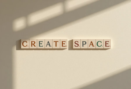 A creative arrangement of letter tiles spelling "CREATE SPACE," casting soft shadows on a neutral background, symbolizing inspiration in home design.の素材