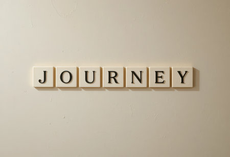 This image features letter tiles spelling "JOURNEY" against a neutral background, symbolizing the path of personal growth and inspiration in life. Perfect for projects on motivation and exploration.の素材