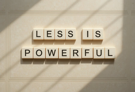 Close-up of minimalist letter tiles spelling "Less Is Powerful," highlighting the simplicity and power found in minimalism. Ideal for motivational concepts.の素材