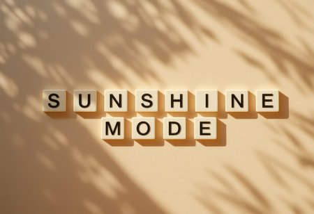 Bright and cheerful letter tiles spell out "Sunshine Mode" against a soft background. Captivating shadows add depth, creating an inspiring vibe perfect for design or lifestyle themes.の素材