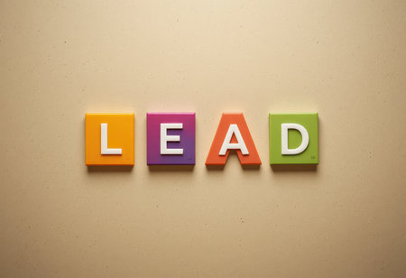 Colorful letter tiles spell out the word "lead" against a beige background, creating a vibrant, playful design suitable for educational or motivational contexts.の素材
