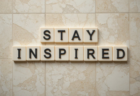 A motivational message that reads "Stay Inspired" displayed with bright letters on a neutral marble background, perfect for uplifting designs or personal use.の素材