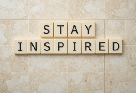 This image features the motivational message "Stay Inspired" composed of letter blocks on a marble tile background, perfect for home decoration or inspiration.の素材