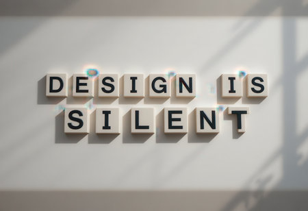This image showcases the powerful message "Design is Silent" displayed on a wall, emphasizing creativity and inspiration in minimalist settings.の素材