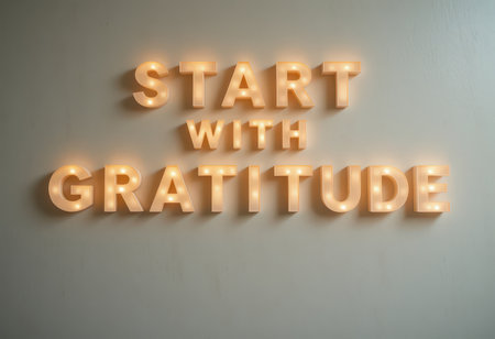 Bright and warm neon sign displaying the phrase "Start with Gratitude" against a neutral wall, perfect for adding a touch of positivity and inspiration to any space.の素材