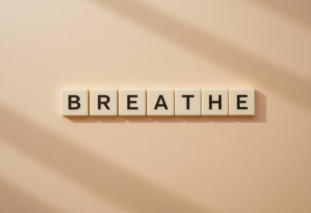 A serene composition featuring letter tiles that spell "Breathe," set against a soft, neutral background, perfect for promoting relaxation and mindfulness.の素材