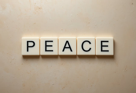 Capture a serene concept with the word "peace" displayed on letter tiles against a neutral background, symbolizing tranquility and positivity in daily life.の素材