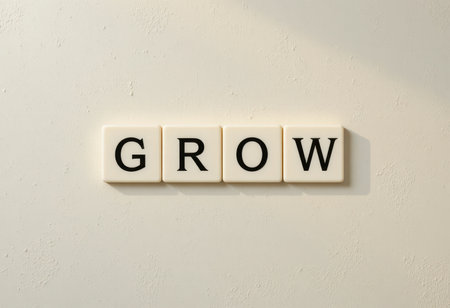 The image features the word "GROW" spelled out with letter tiles against a neutral background. It symbolizes inspiration and personal development, providing a motivational visual.の素材