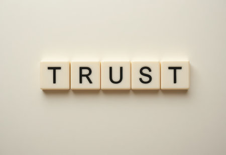 The image highlights the concept of trust with tiles spelling out the word. Trust is essential for healthy relationships, fostering connection and growth.の素材