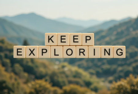 A motivational scene showcasing the words "Keep Exploring" made of letter blocks. The backdrop features serene mountains that evoke a sense of adventure and discovery in nature.の素材