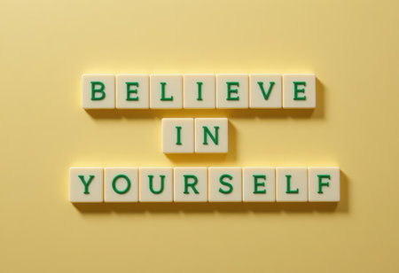 A vibrant arrangement of letter tiles spelling "Believe in Yourself" on a cheerful yellow background. This image embodies motivation and self-affirmation.の素材
