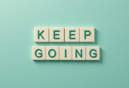 Explore the inspiring message 'Keep Going,' crafted with letter tiles against a calming turquoise background, perfect for motivational content or personal growth themes.の素材