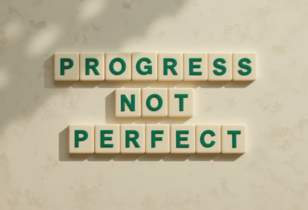 This image features the motivational phrase "Progress Not Perfect" displayed on a light background with soft shadows, perfect for inspiring personal growth and positive thinking.の素材