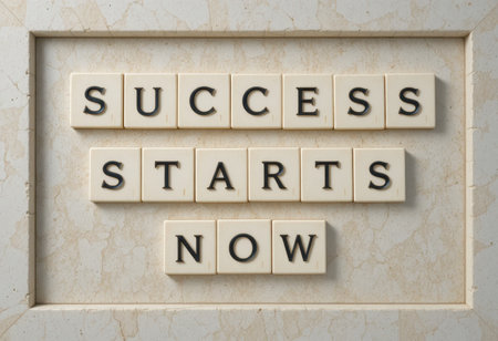 Inspiring image featuring the words "Success Starts Now" crafted with letter tiles on a marble surface. Ideal for motivational themes and personal growth projects.の素材