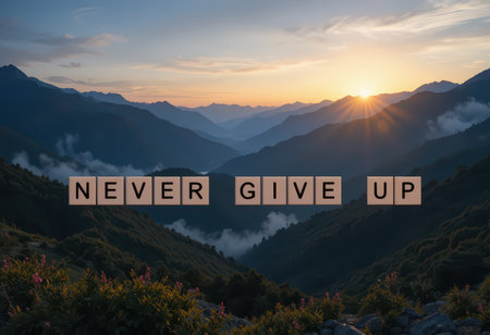 A stunning mountain landscape at sunrise features the words "Never Give Up" crafted from letter blocks. This image symbolizes motivation and perseverance amidst nature's beauty.の素材