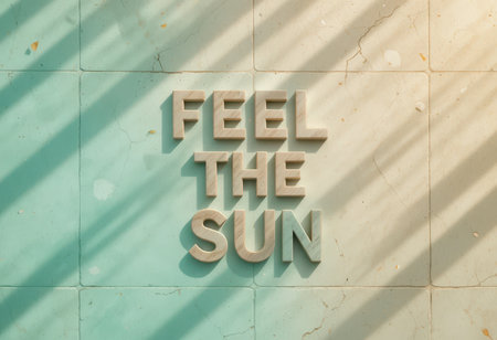 This artistic image features the text "Feel the Sun" against a soft background, enhanced by gentle sunlight shadows. Perfect for motivation or decoration.の素材