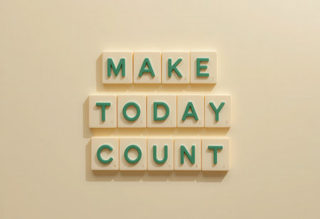 Colorful letter tiles display a motivational quote encouraging individuals to make the most of their day. Perfect for inspirational decor.の素材