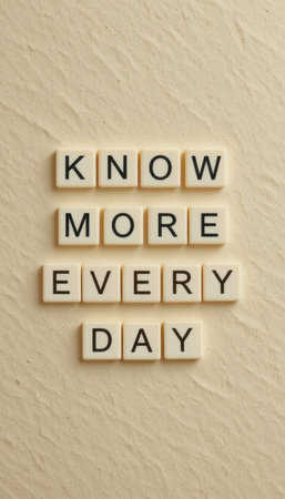 A creative arrangement of letter tiles displaying an inspirational message about learning every day. Ideal for themes around education, growth, and motivation.の素材