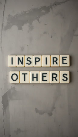A motivational message reading "Inspire Others" displayed on a wall, showcasing modern typography and a minimalist aesthetic. Perfect for personal growth and positivity.の素材