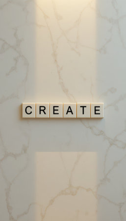 A close-up view of letter tiles spelling "CREATE" on a smooth marble surface, illustrating themes of creativity and inspiration in design projects.の素材
