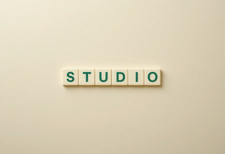 Close-up view of letter tiles arranged to spell the word "STUDIO" on a soft background, ideal for creative projects, workspace designs, and artistic inspiration.の素材