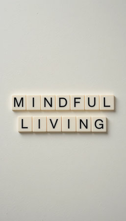 A minimalist arrangement of letter tiles spelling "Mindful Living" emphasizes the importance of mindfulness and balanced lifestyle choices for well-being.の素材