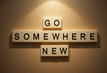 Captivating wall display featuring the motivational phrase "Go Somewhere New" crafted from individual letter tiles, perfect for inspiring creativity and change.の素材