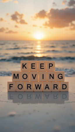 A serene sunset illuminates the ocean as wooden blocks spell out "Keep Moving Forward," symbolizing motivation and positivity in lifeの素材