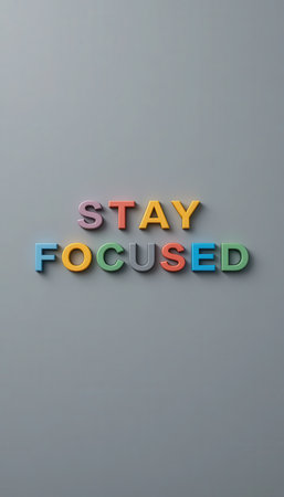 Colorful letters spelling "STAY FOCUSED" create an inspiring visual on a smooth gray background. Perfect for motivational themes and workspace decor.の素材
