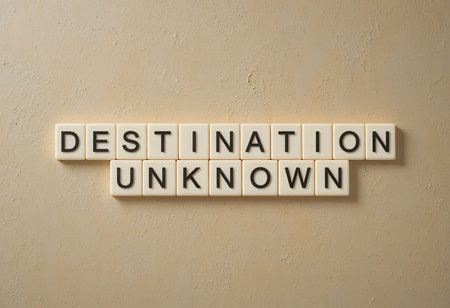 This image features the phrase "Destination Unknown" crafted with block letters against a textured wall, symbolizing the spirit of adventure and discovery in life.の素材
