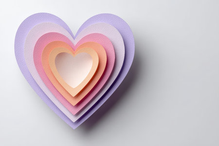 A beautifully crafted layered heart made from colored paper, showcasing soft hues of pink, purple, and orange, perfect for love-themed designs and decorations.の素材