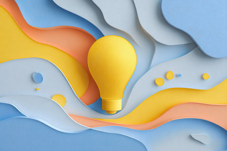 A vibrant yellow light bulb stands out against a backdrop of colorful layered paper waves in blue and orange. This artistic composition embodies creativity and warmth.の素材