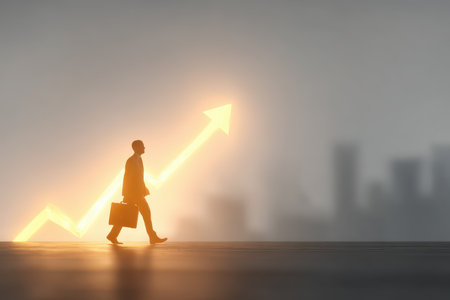 A silhouette of a businessman walking toward a glowing upward arrow, symbolizing hope and growth. The background features a blurred cityscape, suggesting the urban business environment.の素材