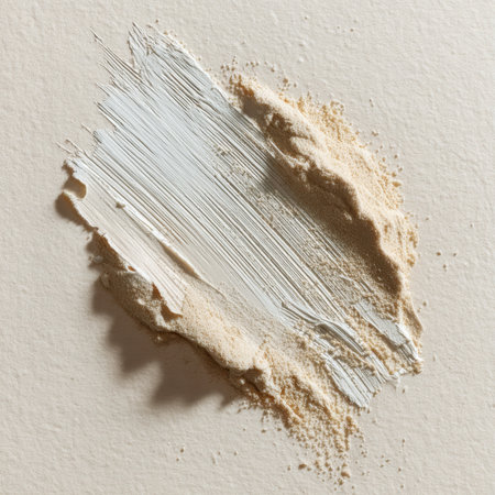 A delicate light gray and beige paint swatch on a textured white surface, showcasing artistic elegance and minimalism ideal for creative projects or interior design inspiration.の素材