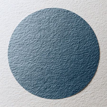 A close-up view of a textured circular surface featuring a sophisticated blue-gray tone against a light background, ideal for modern design projects.の素材