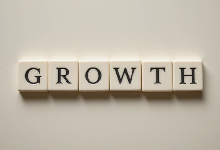 This image features letter tiles spelling the word "GROWTH" against a clean white background, symbolizing the journey of personal and professional development.の素材