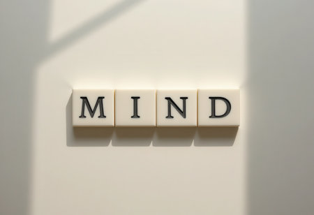 Letter tiles spelling "MIND" on a clean backdrop symbolize ideas and awareness. This image evokes themes of creativity, thinking, and personal development.の素材