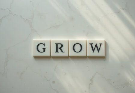 A captivating arrangement of tiles spelling "GROW" offers an inspiring message for personal development. The interplay of light and shadow enhances the visual appeal.の素材