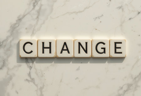 This image features letter tiles spelling "CHANGE" set against a marble surface, symbolizing transformation and growth in personal or professional context.の素材