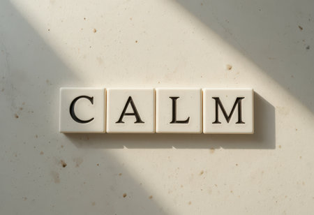 This image features the word "calm" spelled out in elegant letters on a bright surface, emphasizing tranquility and relaxation through minimalist design and soft shadows.の素材
