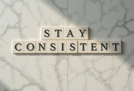 This image features the motivational phrase "Stay Consistent" arranged in letters against a marble background, symbolizing determination and focus.の素材
