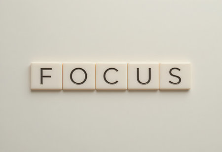 This image features the word "FOCUS" crafted from letter tiles against a soft background, conveying a sense of clarity and motivation for personal growth.の素材