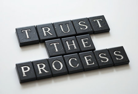 This image showcases the inspirational phrase "Trust the Process" arranged with black square tiles. Perfect for conveying motivation and growth themes in various projects.の素材