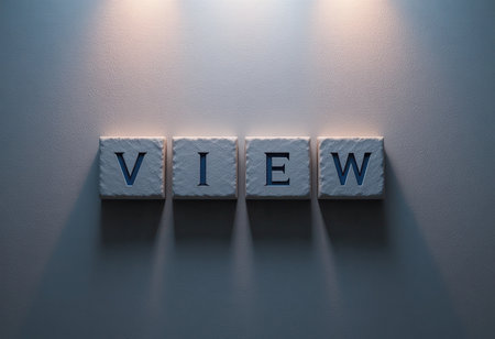 This image features elegant letter blocks spelling the word "VIEW" with soft lighting illuminating a textured wall. It evokes a modern and creative atmosphere.の素材