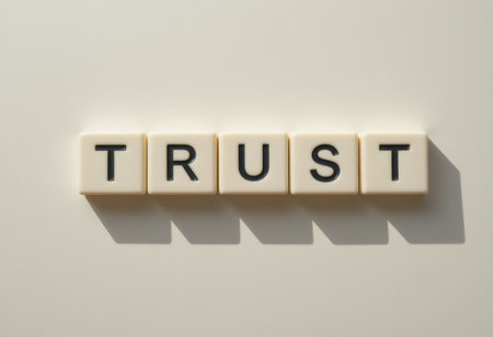 This image showcases the word "TRUST" formed with letter tiles against a light background, symbolizing the importance of trust in relationships and communication.の素材