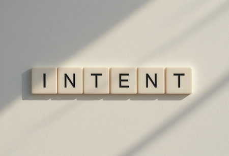 This image features the word "INTENT" formed with letter tiles on a minimalist white background, evoking themes of purpose, focus, and creativity. Perfect for projects related to motivation and personal growth.の素材